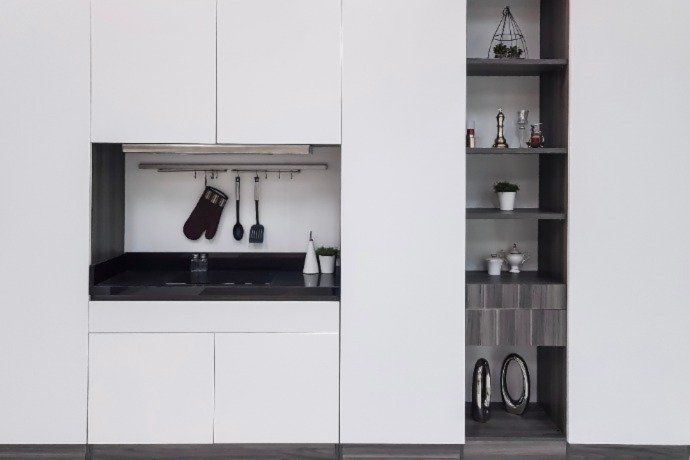 pocket door kitchen pantry with white cabinets