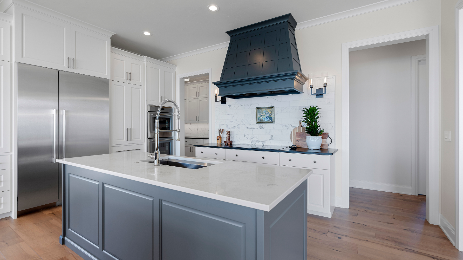 Stylish kitchen with a large functional island and hanging range hood