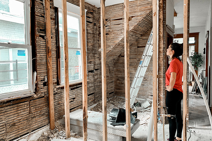 A person standing in the commercial space under construction 