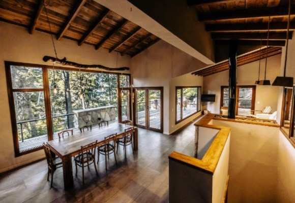 spacious living room with wooden flooring and big windows