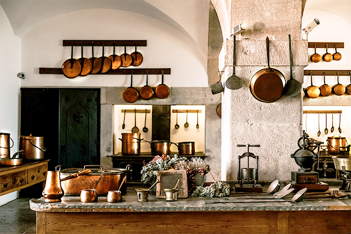 Kitchen built with rustic copper counters and cookware.