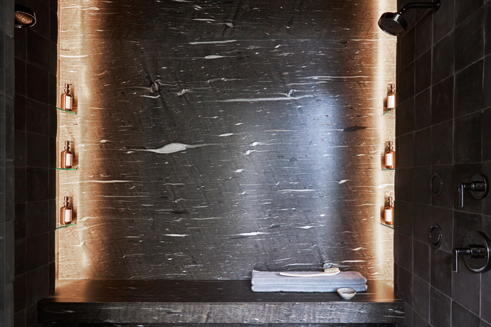 Dark colored bathroom with accent lighting