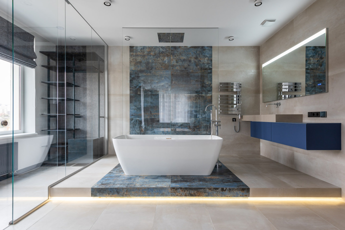 spacious bathroom with lit up tile flooring, big bath tub in the middle, big lit up window