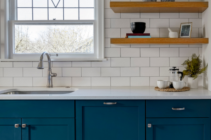 personalized galley kitchen with dark blue cabinets and wooden shelves