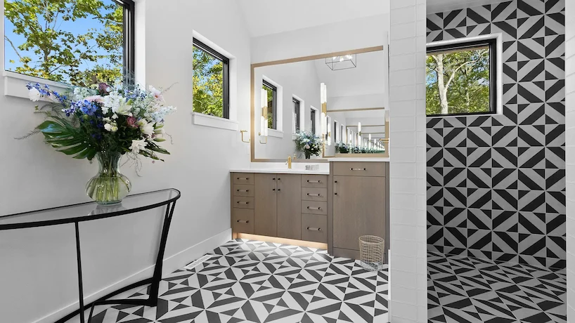 primary bathroom with dramatic black and white tiling on the floor and in the shower