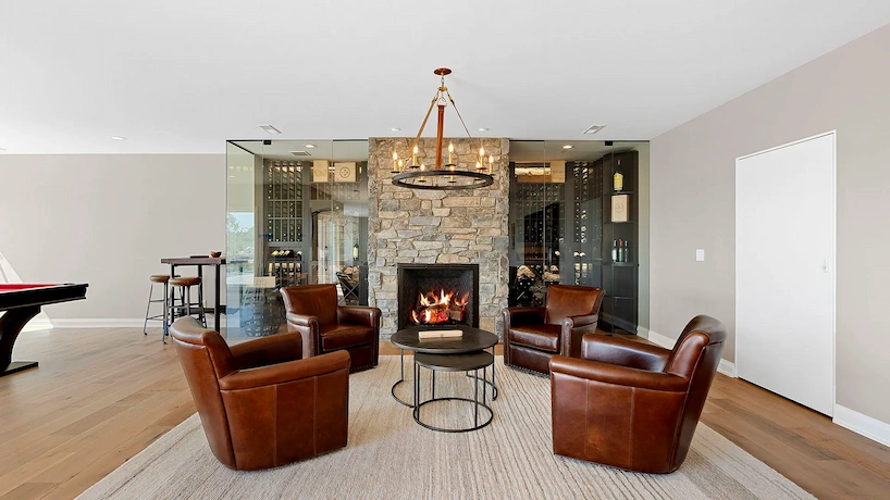 Beautiful basement remodel with a new wine cellar with stone finishing. Complimented with luxurious leather lounge chairs and a billiards table.