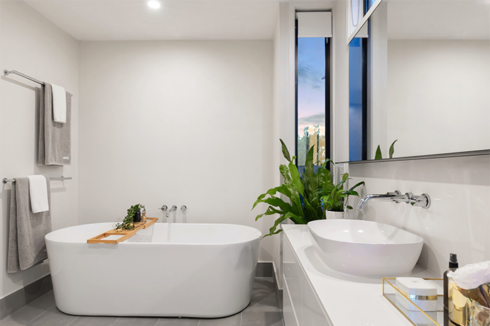 All white freestanding basin bathroom design.