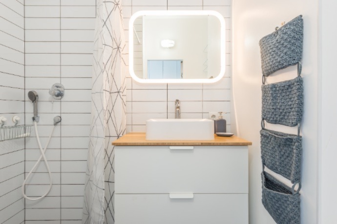 small bathroom with added storage space hang up on the door 