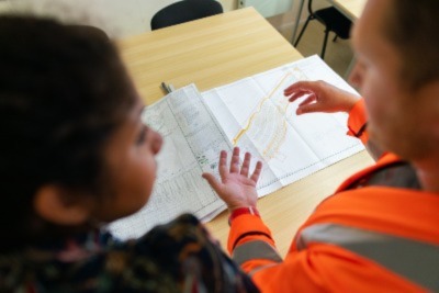 a contractor explaining a client the plan for building a warehouse