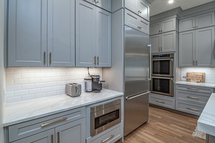 Kitchen built with classic brushed stainless steel handles and kitchen appliance.