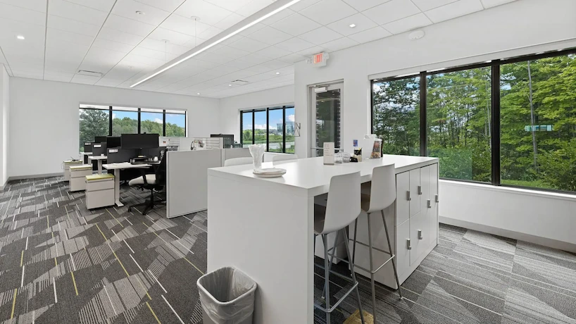 renovated office area with white desks and fresh carpet