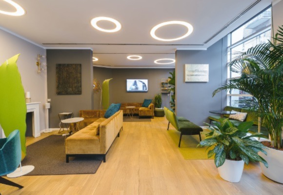 spacious lobby of the medical office with lots of plants and earthy colors