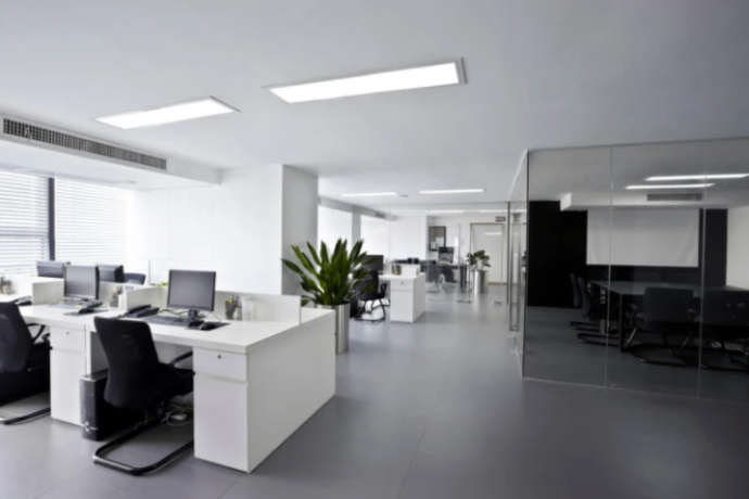 office space with dark furniture and black tile flooring