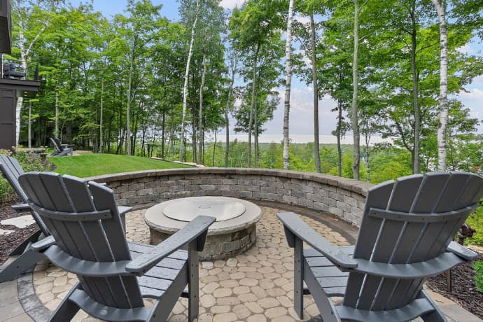 patio of the house surrounded by tall tress and the forest