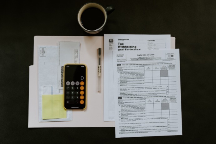 tax form with calculator on the table to calculate tax credit for environmental home