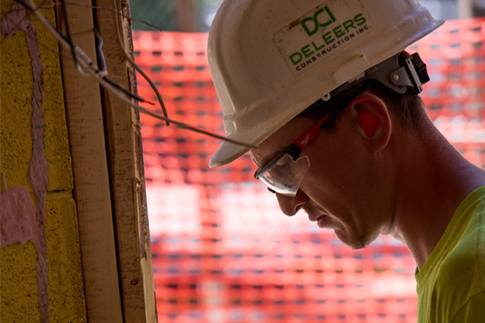 Worker wearing protective glasses and hard hat