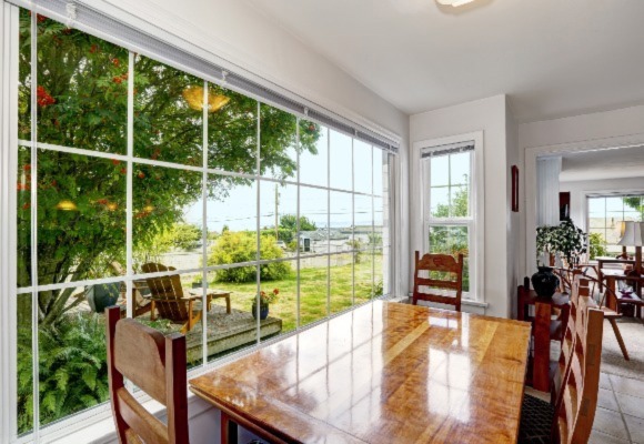 big window in the living room with trees outside