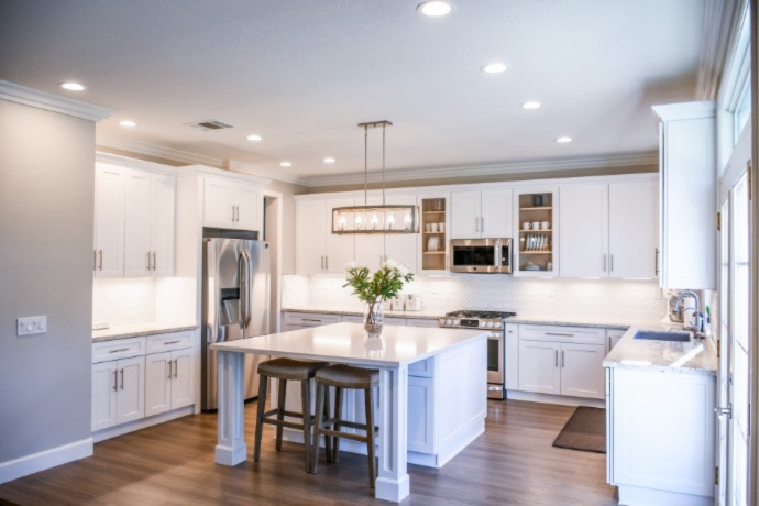 big white spacious kitchen with warm overhead light