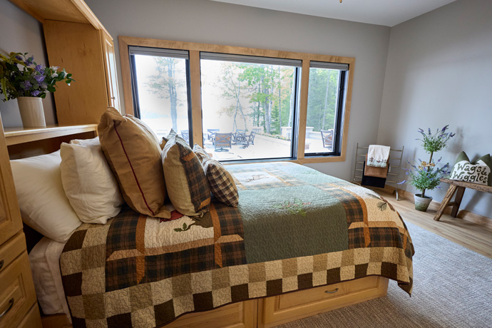 A rustic bedroom with white painted walls