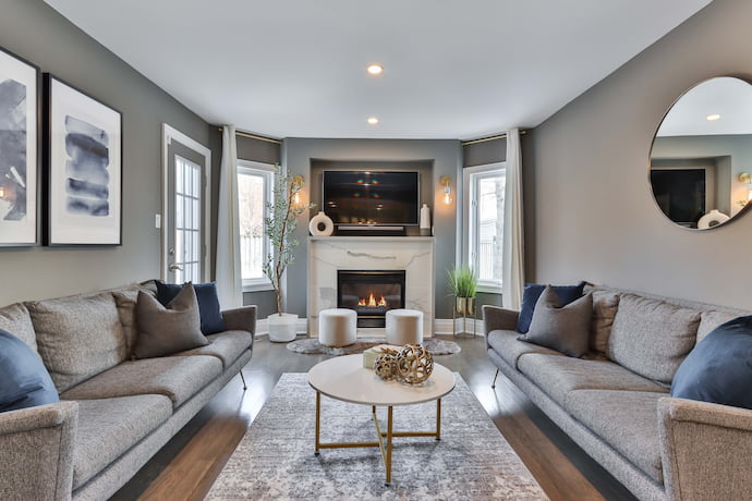 spacious living room with a fireplace and two couches