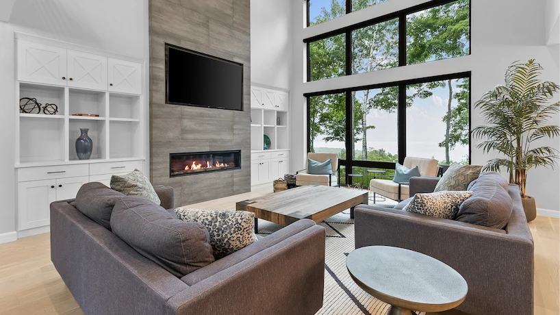 newly remodeled living room with wood flooring and stone fireplace