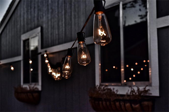 a house with soft string light out in the backyard