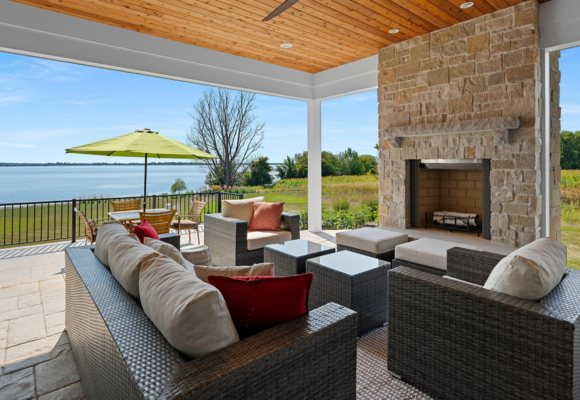 Patio with the outside couch, fireplace, and  with the view of the lake