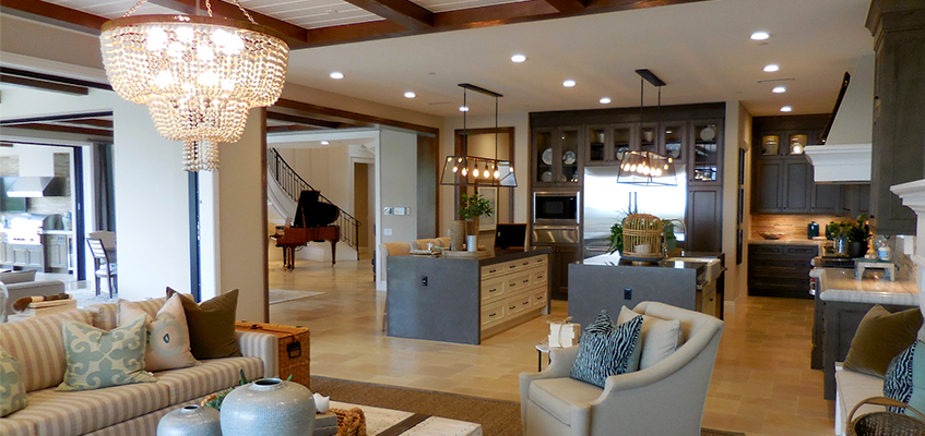 big dinning room with shiny chandelier, staircase in the back 