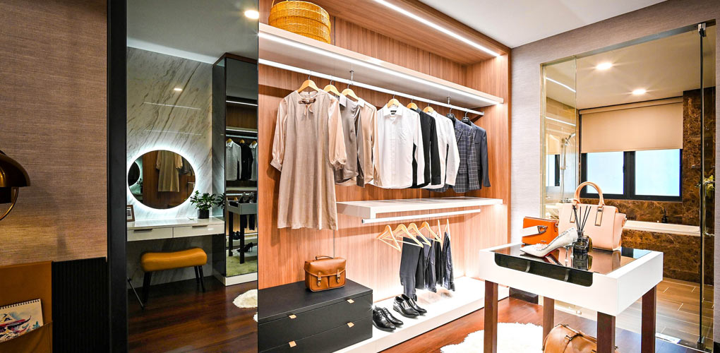 walk-in closet with mirrors in the spare room