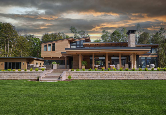 Exterior of a luxury home built by the woods.
