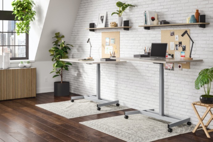 an office space with standing desks and floating shelves above them 