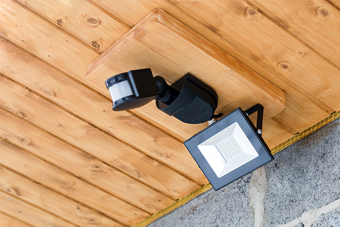 motion sensor light attached to the roof of the house