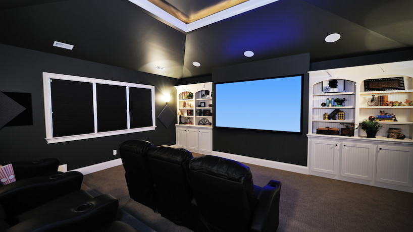 luxury home theater with movie seats and big screen