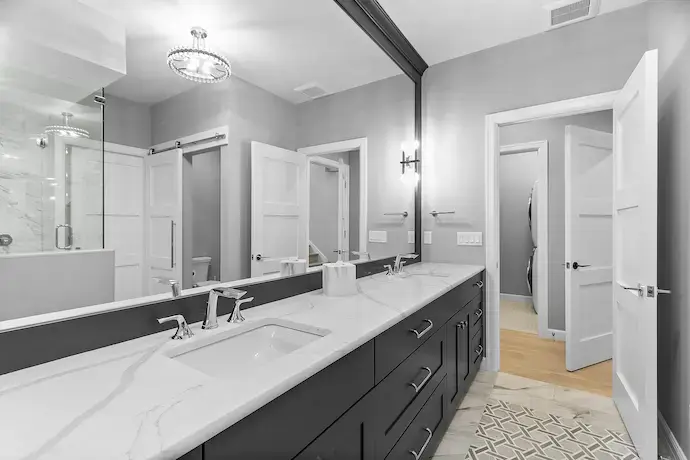 spacious bathroom with lit up tile flooring, big bath tub in the middle, big lit up window