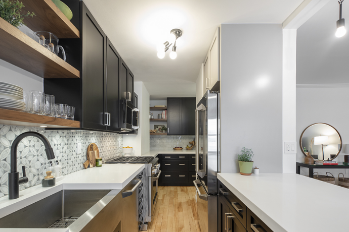 galley kitchen with dark brown cabinets and overhead lighting 