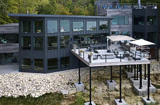 Modern black luxury home nestled in the woods.
