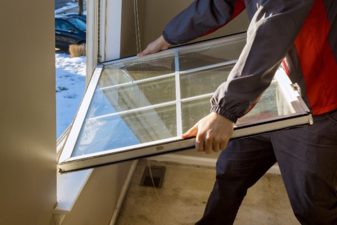 a worker sizing a window in a new house