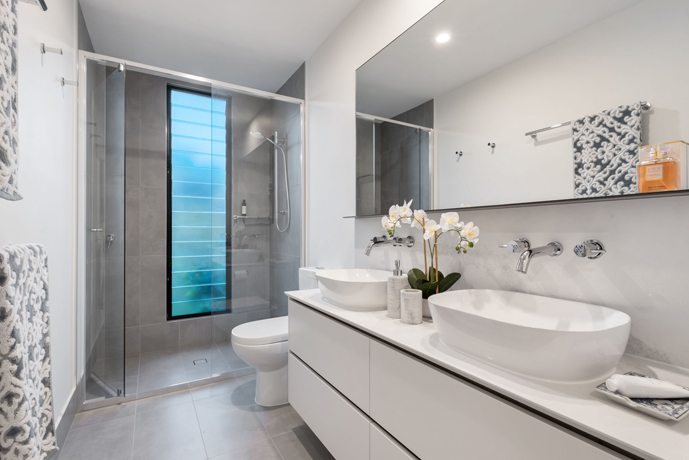 Wet room bathroom design in airy white and blue accents.