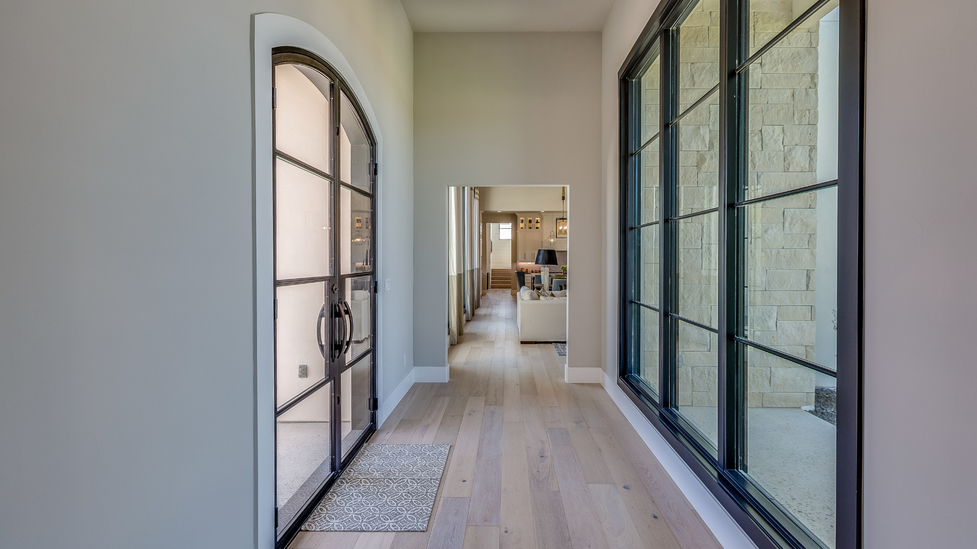 Hallway with wood flooring and French doors