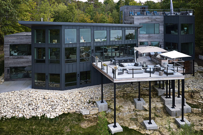 Black modern luxury home in the woods.