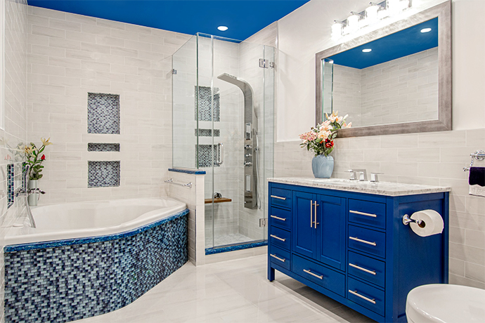 White bathroom with blue tile and furniture giving a Mediterranean feel.