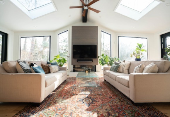 spacious living room with a ceiling fan 
