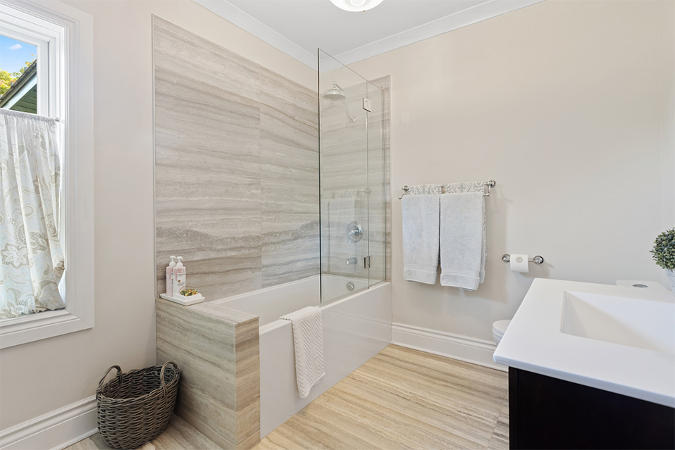 Combined white bath tub with shower.