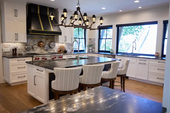 spacious kitchen, ceiling light, dark cupboards, tile flooring and a big window