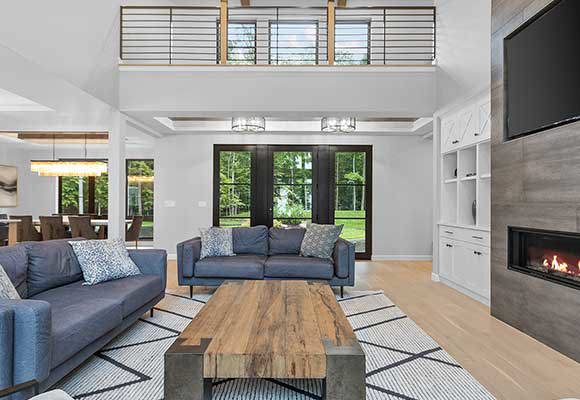 Modern home remodel of living room with recessed fireplace and wood coffee table.