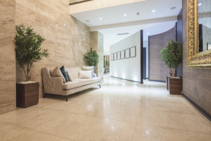 office lobby with light colored shiny tile and a couch