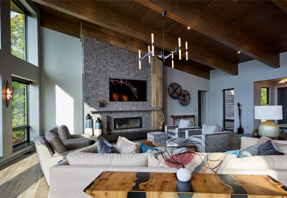 Natural colored living room with stone accent and wood ceiling