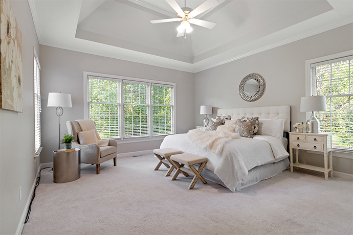 Large windows shining natural light into bedroom