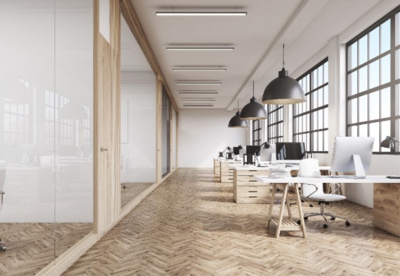 office space with light colored wooden floors and white furniture