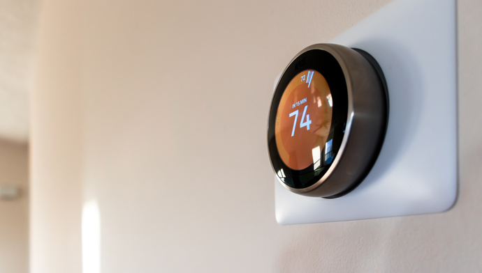 Smart home thermostat mounted on wall.